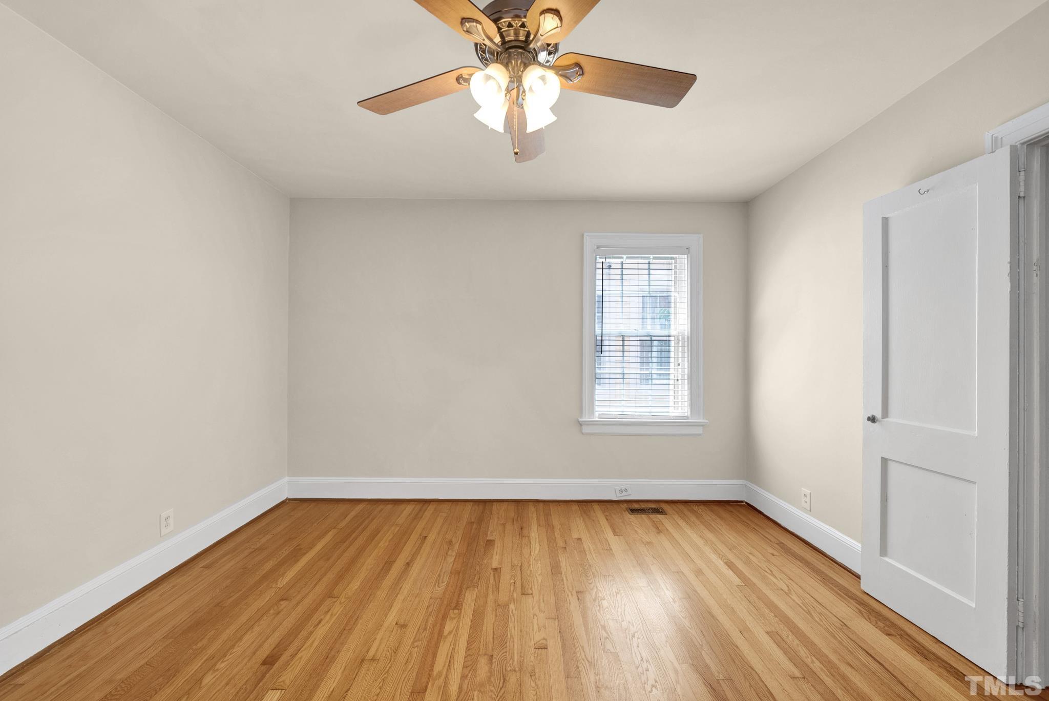 10 Dixie Trail Raleigh, NC 27607 - Photo 16 of 27 a view of empty room with wooden floor and fan