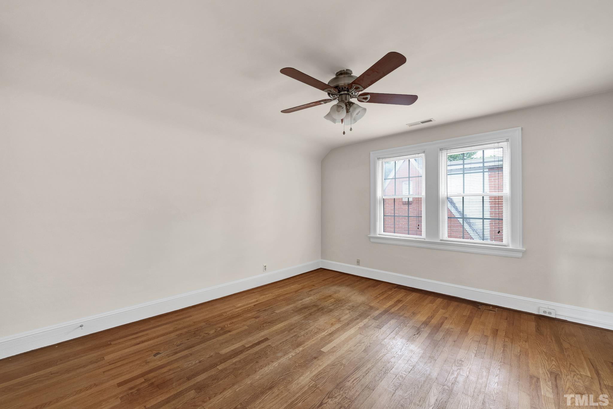 10 Dixie Trail Raleigh, NC 27607 - Photo 18 of 27 a view of an empty room with wooden floor and a window