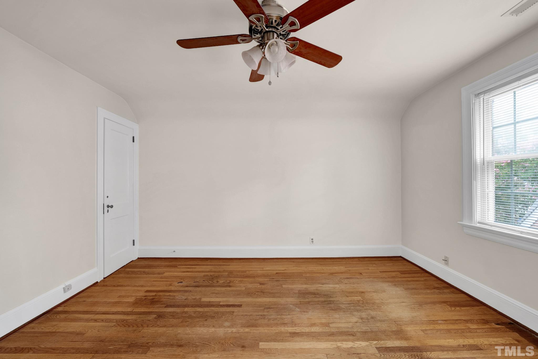 10 Dixie Trail Raleigh, NC 27607 - Photo 19 of 27 a view of an empty room with window and wooden floor