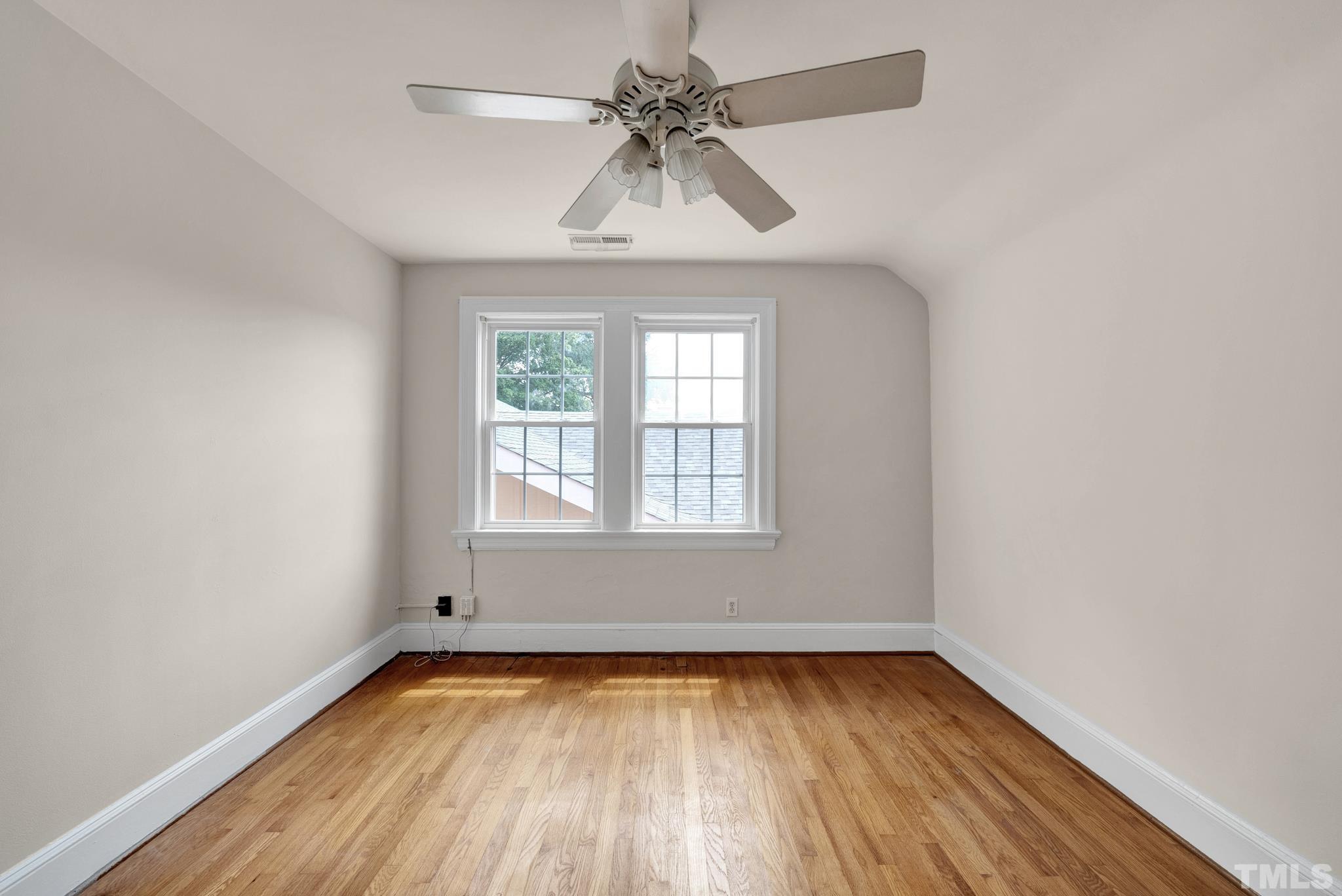 10 Dixie Trail Raleigh, NC 27607 - Photo 21 of 27 an empty room with a window and a chandelier fan