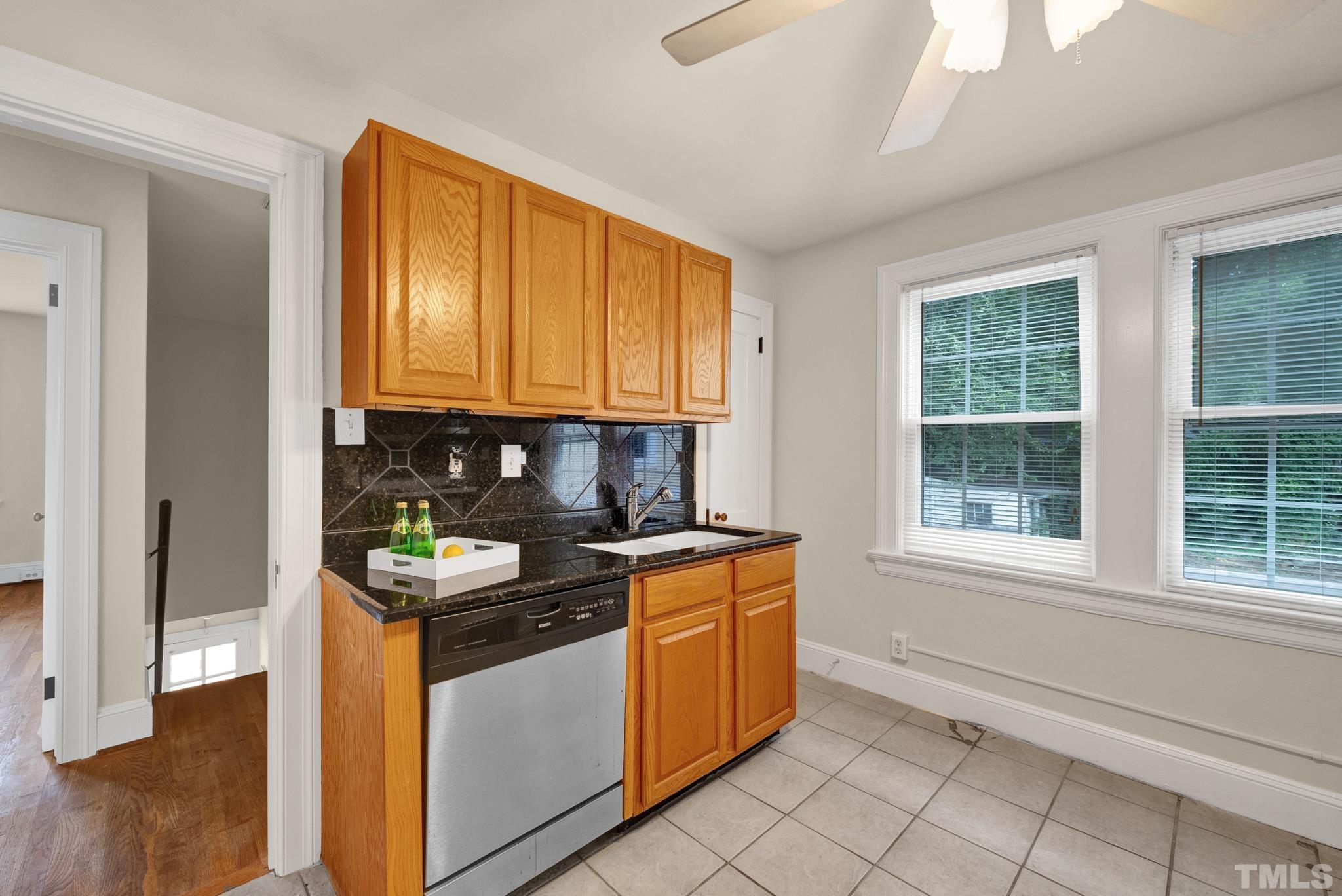 10 Dixie Trail Raleigh, NC 27607 - Photo 23 of 27 a kitchen with stainless steel appliances granite countertop a stove a sink and a microwave
