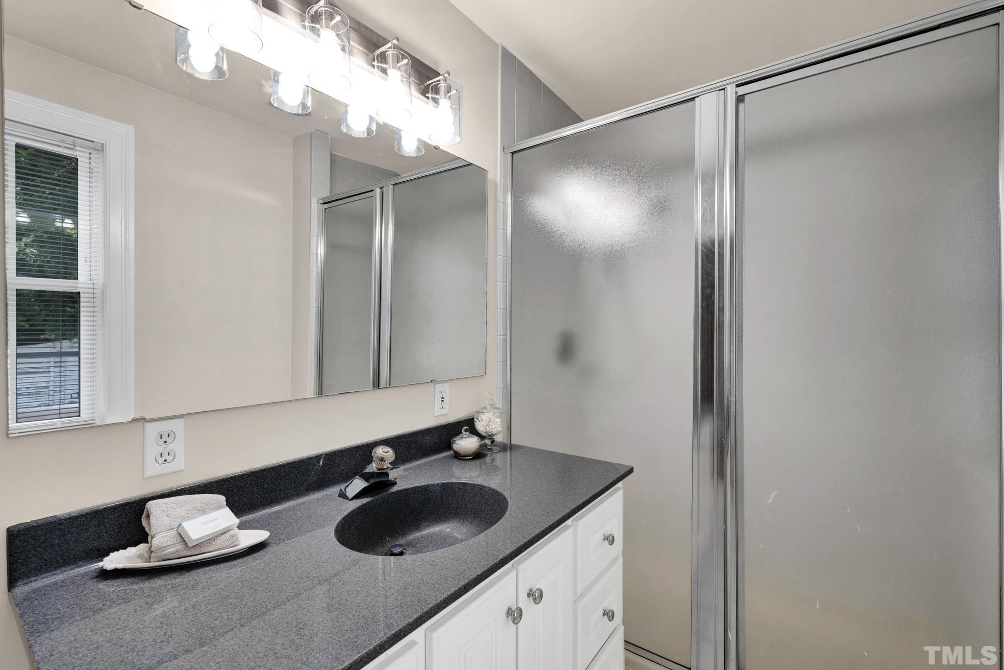 10 Dixie Trail Raleigh, NC 27607 - Photo 24 of 27 a bathroom with a granite countertop sink and a mirror