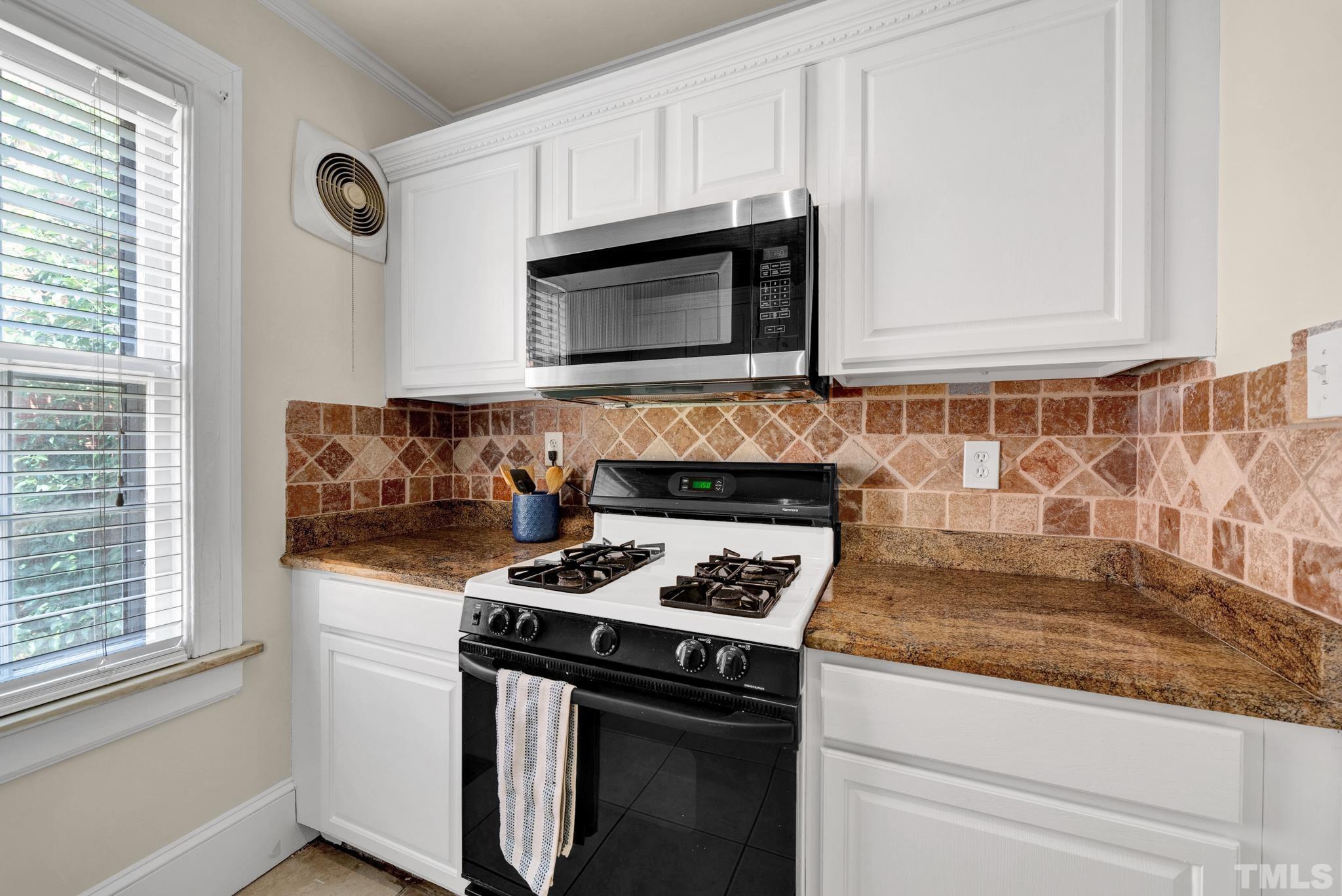 10 Dixie Trail Raleigh, NC 27607 - Photo 9 of 27 a kitchen with granite countertop stainless steel appliances a stove a sink and a microwave