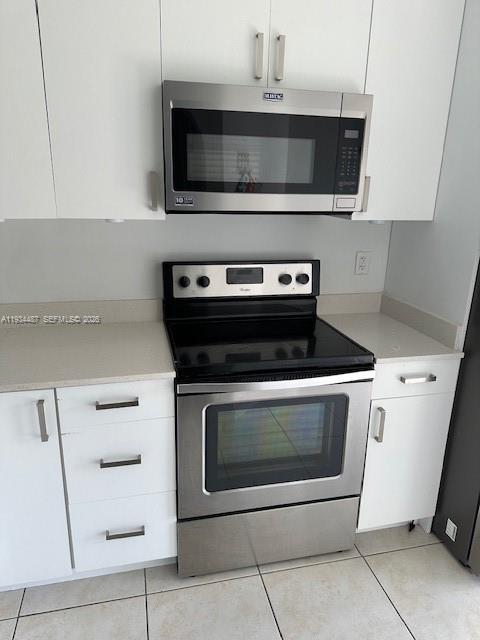 1250 Southeast 26th Street, Unit 102 Homestead, FL 33035 - Photo 5 of 16 a stove top oven sitting inside of a kitchen