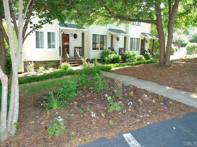 7612 Huey Court Raleigh, NC 27615 - Photo 3 of 6 a front view of a house with garden