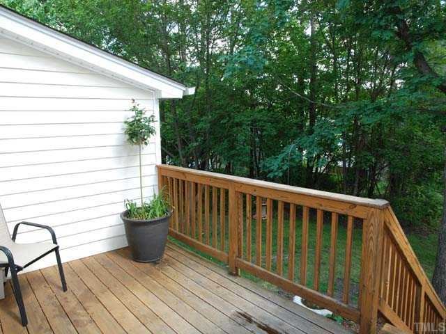 7612 Huey Court Raleigh, NC 27615 - Photo 4 of 6 a view of a chair and table on the wooden deck