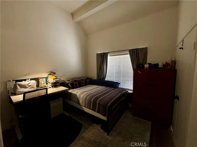 a bedroom with bed and window