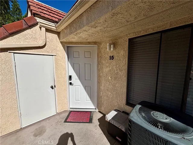 a hallway with stairs and a couch