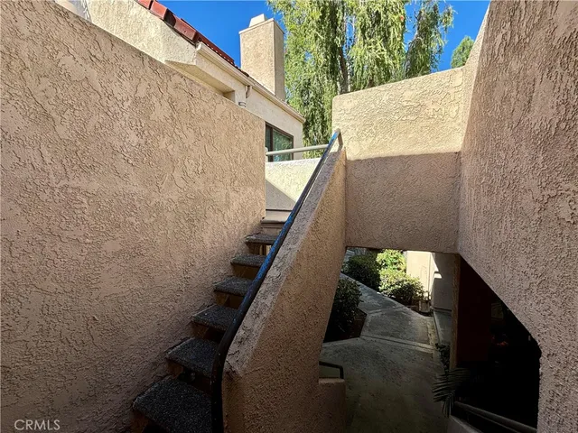 a view of balcony with wooden floor and fence