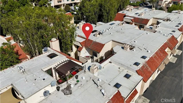 an aerial view of a house with a yard