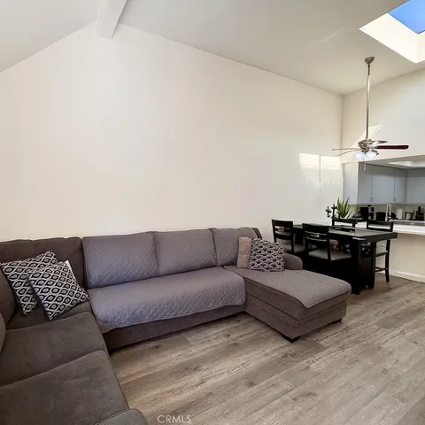 a living room with furniture and kitchen view