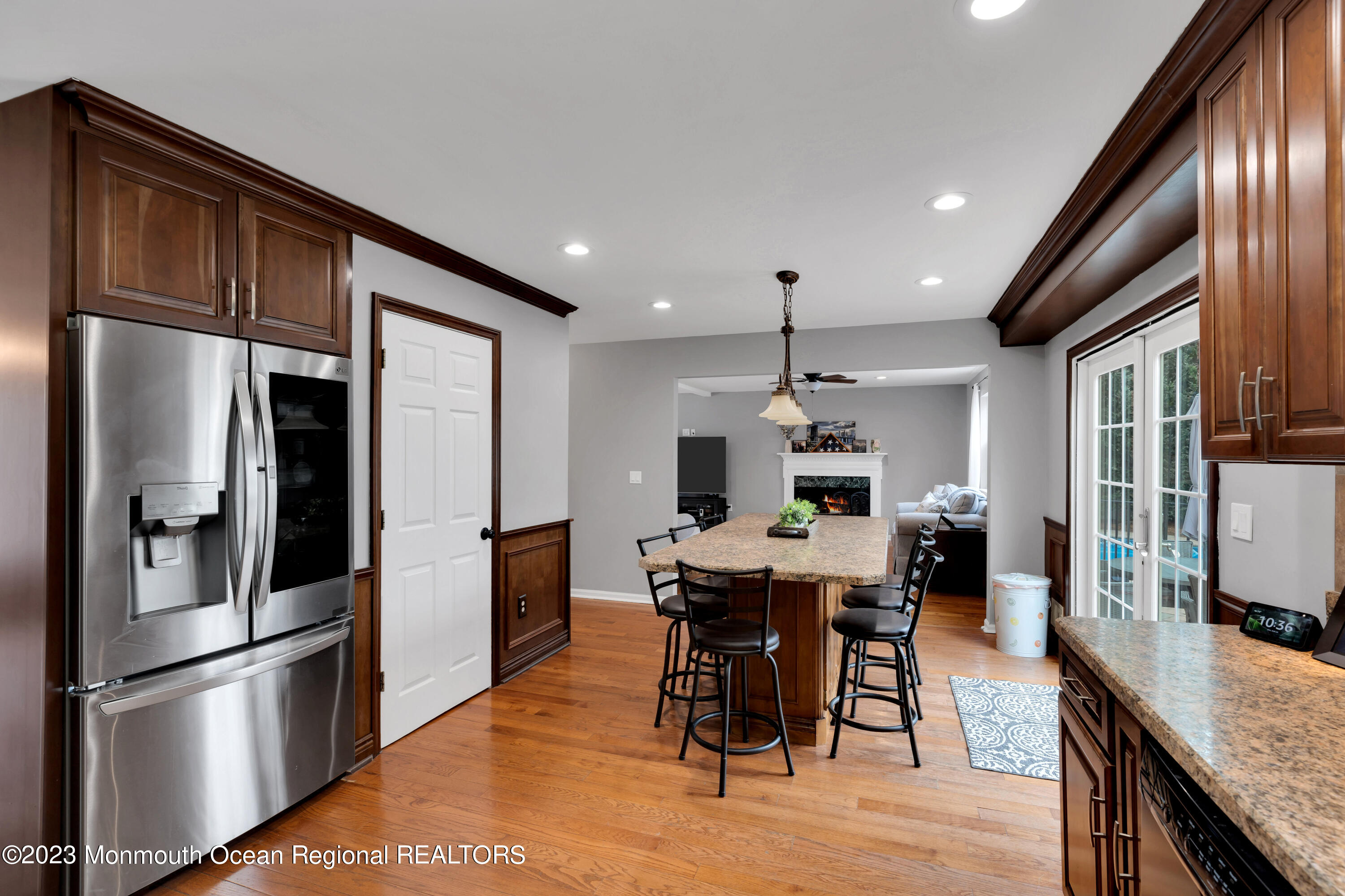 5 Autumn Drive Howell, NJ 07731 - Photo 23 of 50 a kitchen with stainless steel appliances kitchen island granite countertop a refrigerator a stove a sink a dining table and chairs with wooden floor