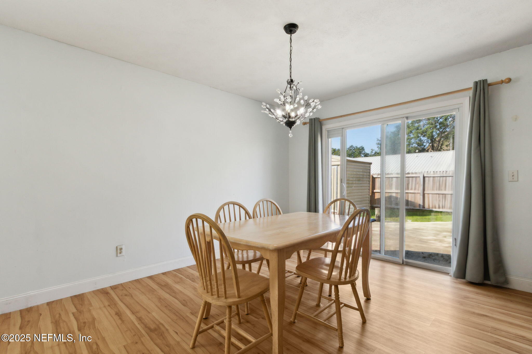 234 Hawthorne Road St. Augustine, FL 32086 - Photo 14 of 29 a view of a dining room with furniture wooden floor and chandelier