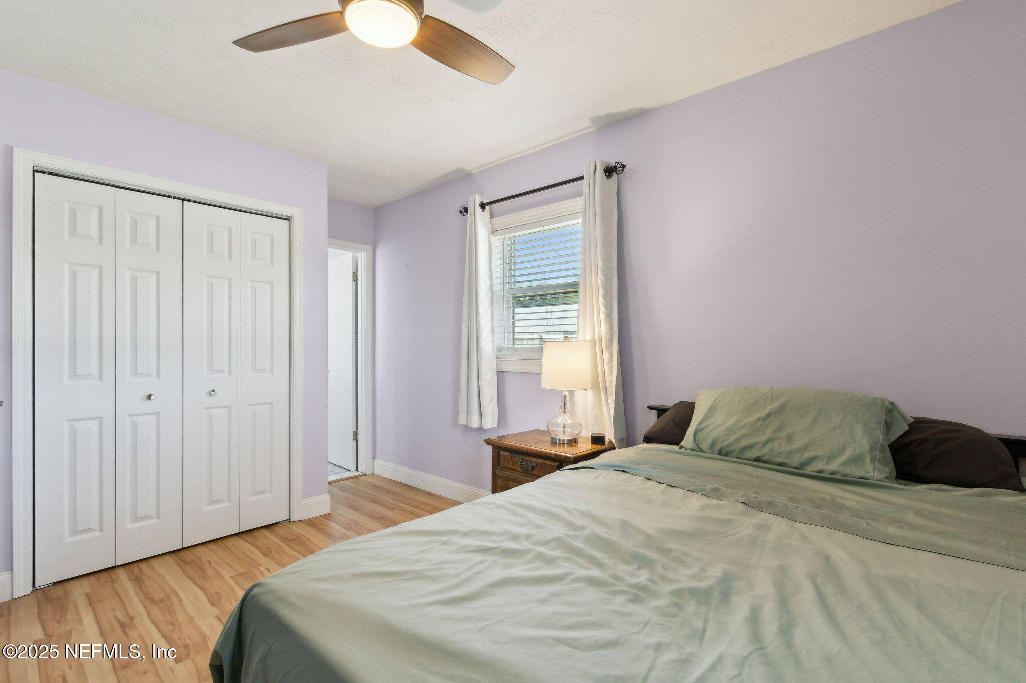 234 Hawthorne Road St. Augustine, FL 32086 - Photo 18 of 29 a bedroom with a bed and a chandelier