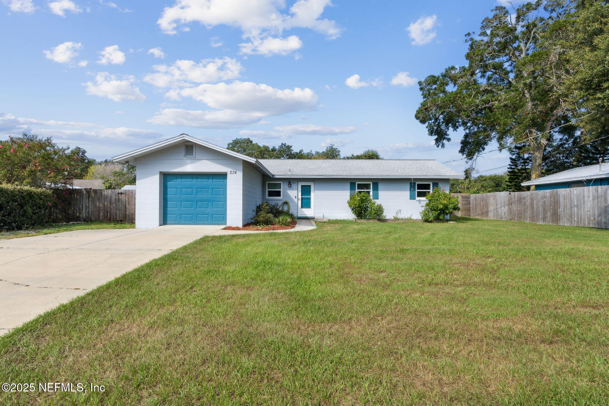 234 Hawthorne Road St. Augustine, FL 32086 - Photo 2 of 29 a front view of a house with a garden
