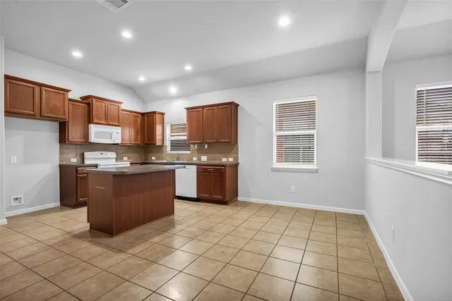 a kitchen with a sink a counter top space and appliances
