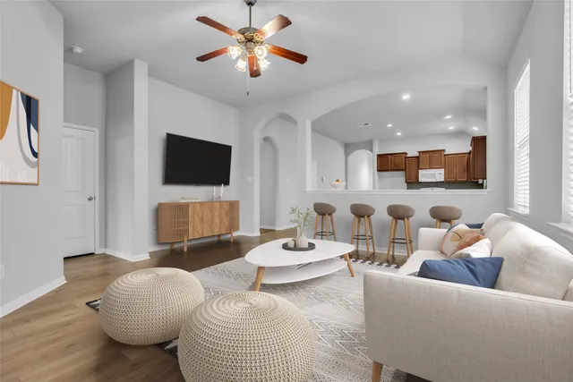 a living room with furniture and a flat screen tv