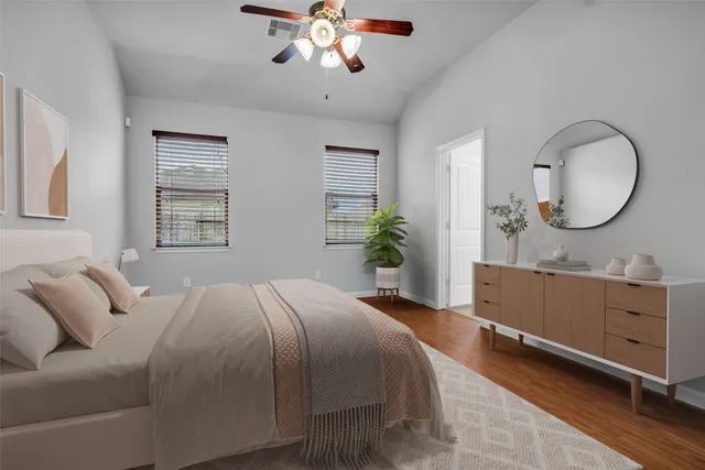 a bedroom with a large bed and a chandelier