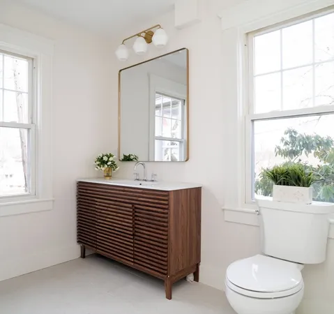 a bathroom with a sink toilet and window