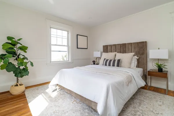 a bedroom with bed and a window