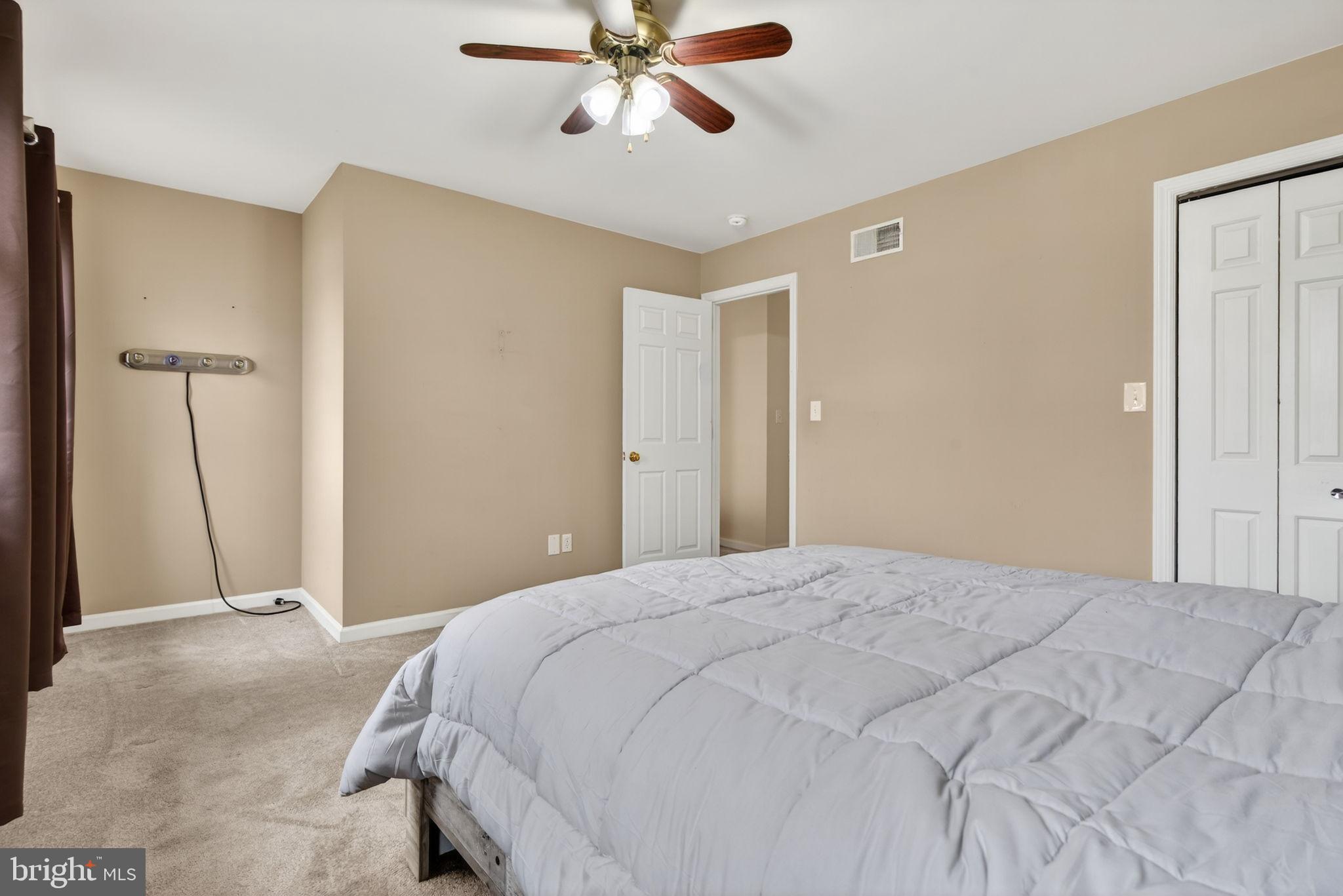 64 Beech Lane Elizabethtown, PA 17022 - Photo 14 of 26 a bedroom with a large bed and a chandelier