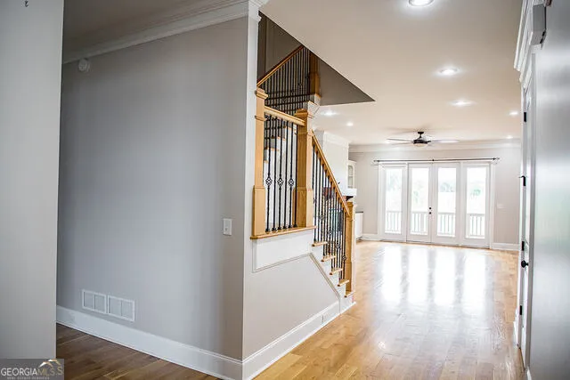 a view of an entryway with wooden floor and door