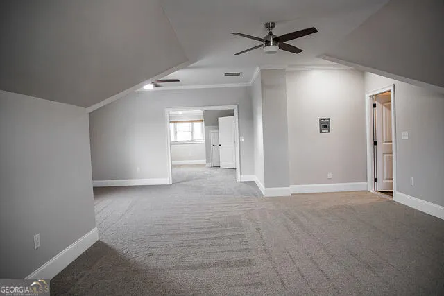an empty room with fan and windows