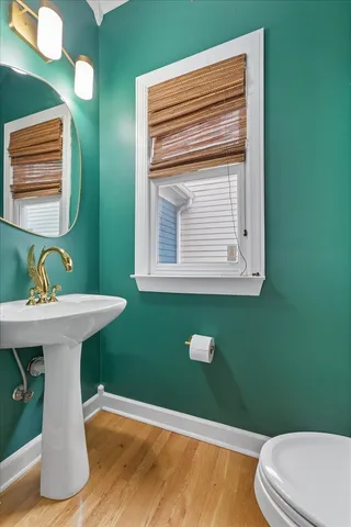 a bathroom with a sink mirror and toilet
