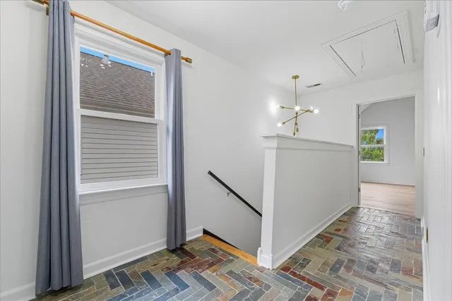a view of a hallway view with wooden floor and staircase