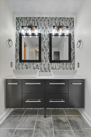 a bathroom with a sink and a mirror