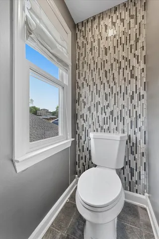 a white toilet sitting next to a shower curtain