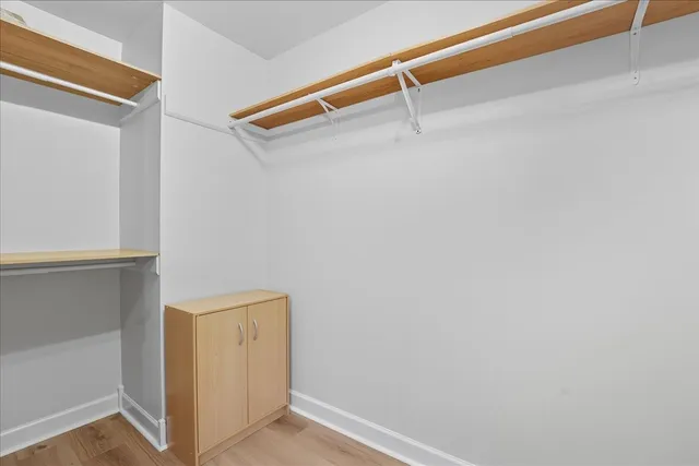 a view of walk in closet with empty racks