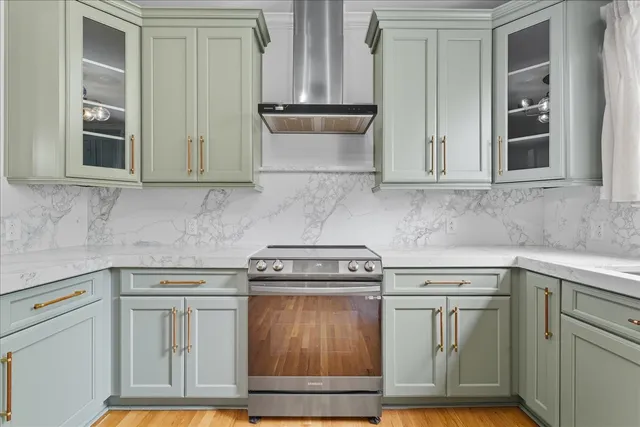 a kitchen with granite countertop white cabinets and stainless steel appliances