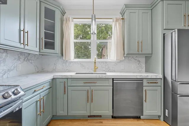a kitchen with stainless steel appliances granite countertop a sink stove and refrigerator