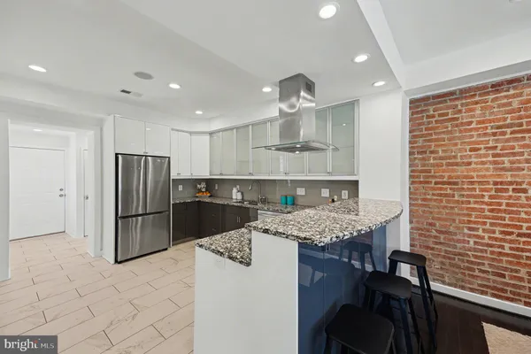 a kitchen with a cabinets and steel stainless steel appliances