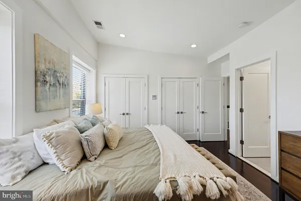 a bedroom with a large bed and a window