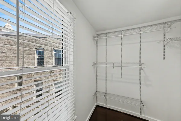 a bathroom with a granite countertop bathtub shower sink mirror and toilet