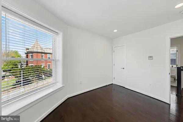 a living room with a bed furniture and a window