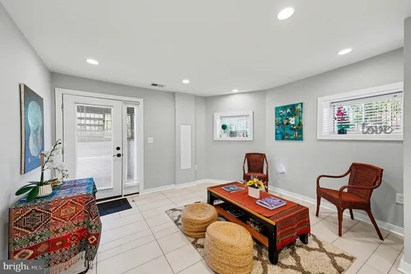 a living room with furniture and kitchen view