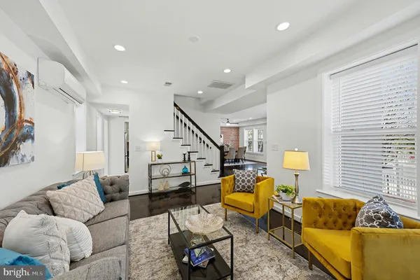 a living room with furniture and stairs