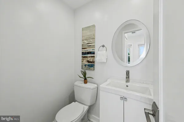 a bathroom with a toilet a sink and a mirror