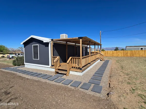 a view of a wooden deck with a yard