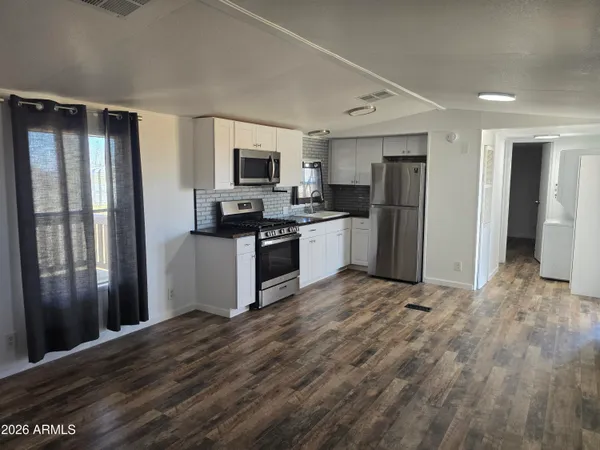 a kitchen with stainless steel appliances granite countertop a refrigerator stove and oven