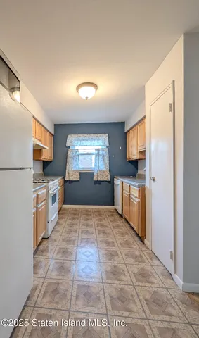 a kitchen with granite countertop a refrigerator and a stove top oven
