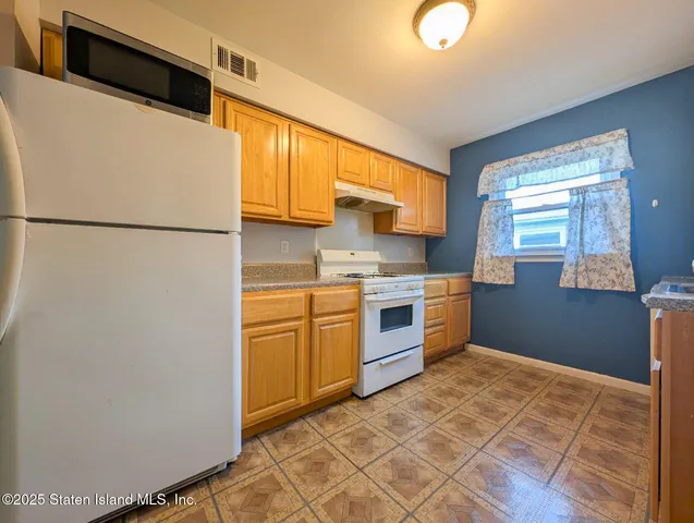 a kitchen with stainless steel appliances granite countertop a refrigerator sink and cabinets