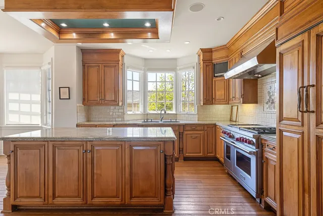 a kitchen with stainless steel appliances granite countertop a stove and a refrigerator