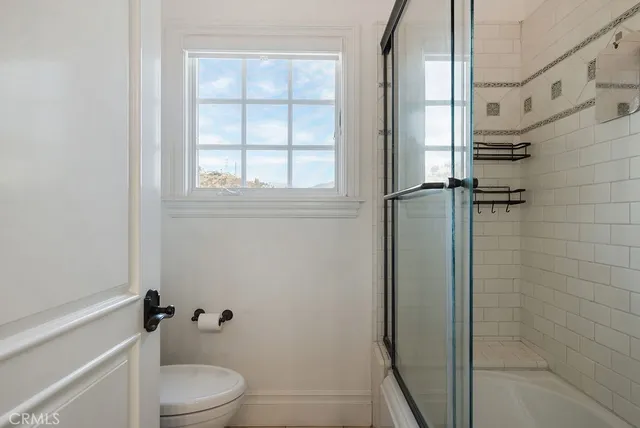 a white toilet sitting next to a bathroom sink