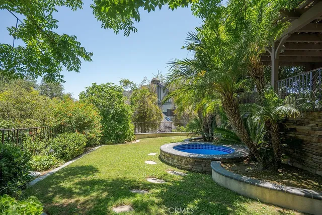 a backyard of a house with a yard and outdoor seating