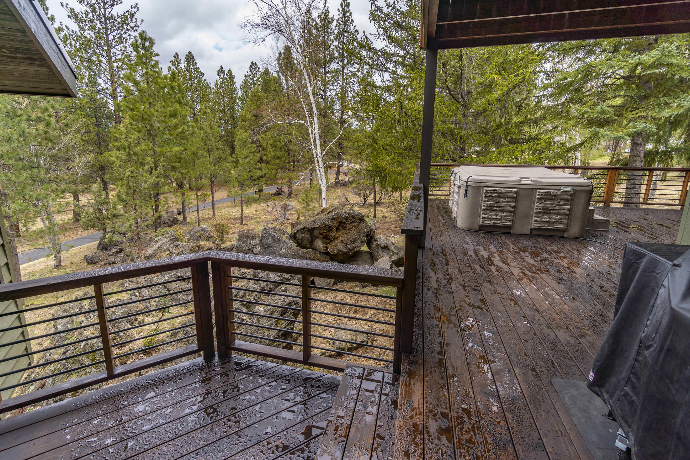 60010 East Ridgeview Drive Bend, OR 97702 - Photo 33 of 43 a view of a deck with wooden floor and fence next to a yard