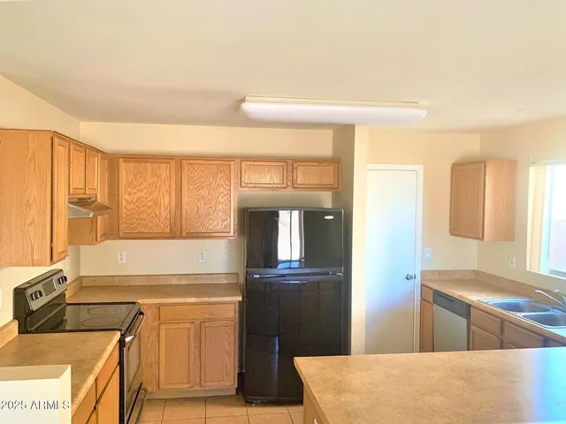 a kitchen with stainless steel appliances granite countertop a stove and a refrigerator
